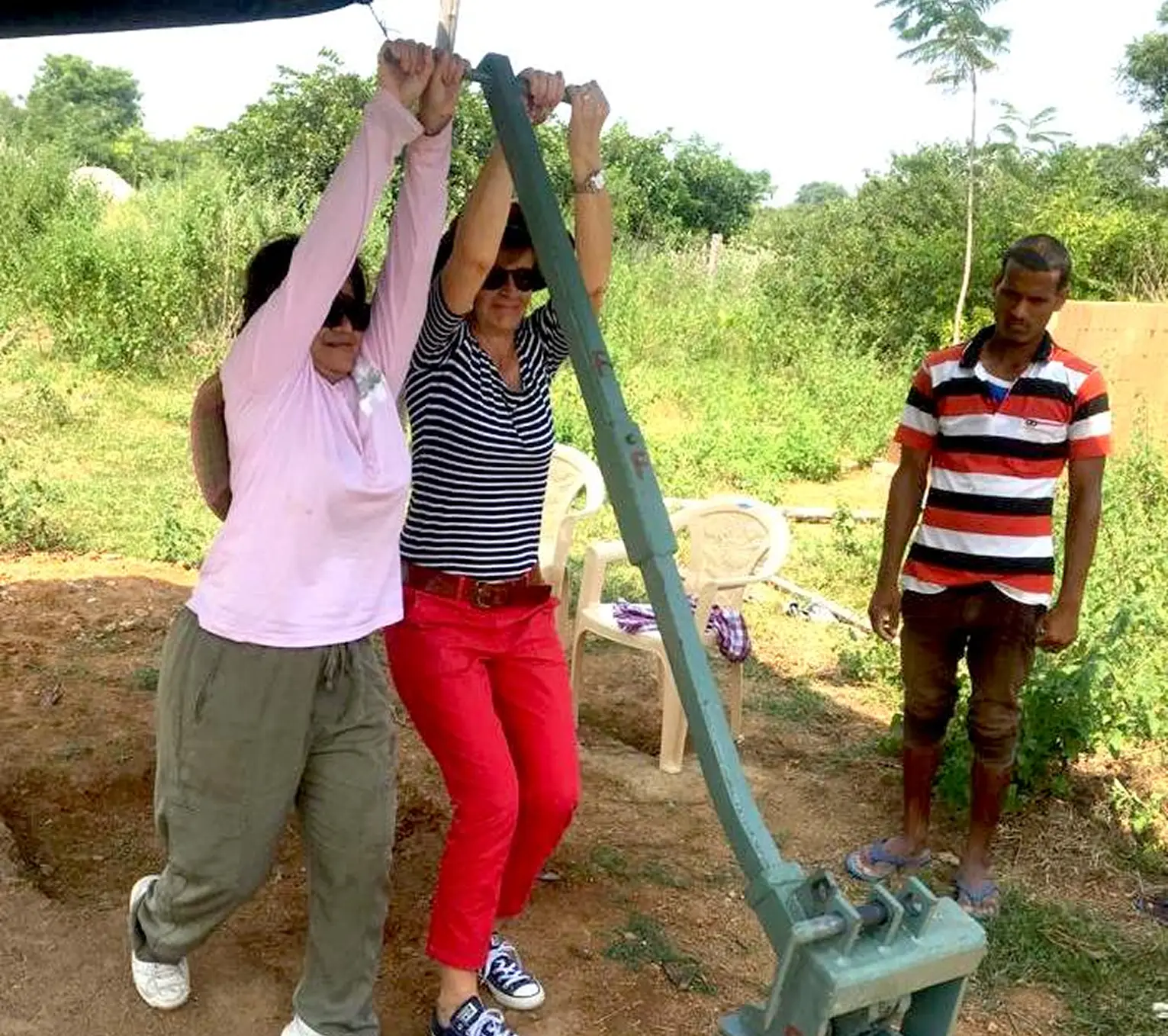 Two people using a seesaw outdoors.