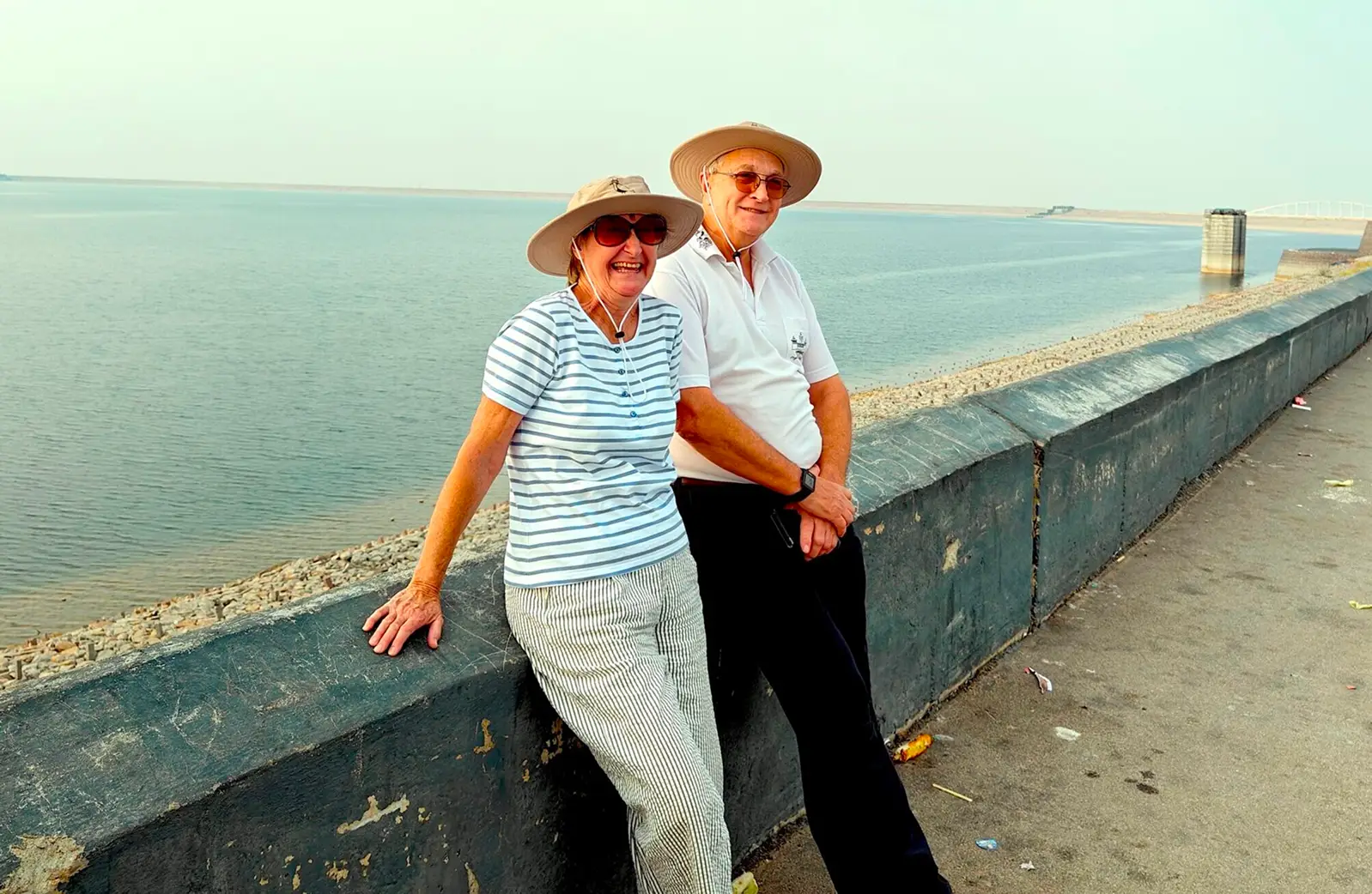 Couple sitting by the water.