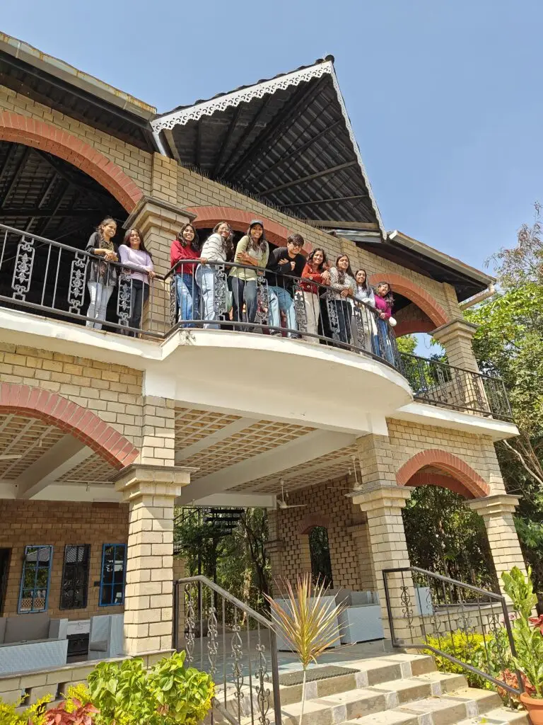 Group of people on balcony of pool pavilion