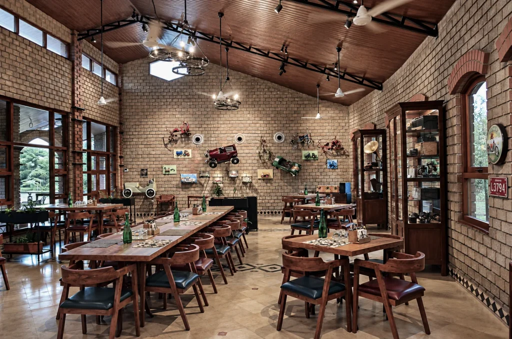 Warmly lit café interior with patterned floor tiles at Arbor Road Estate near Hyderabad.