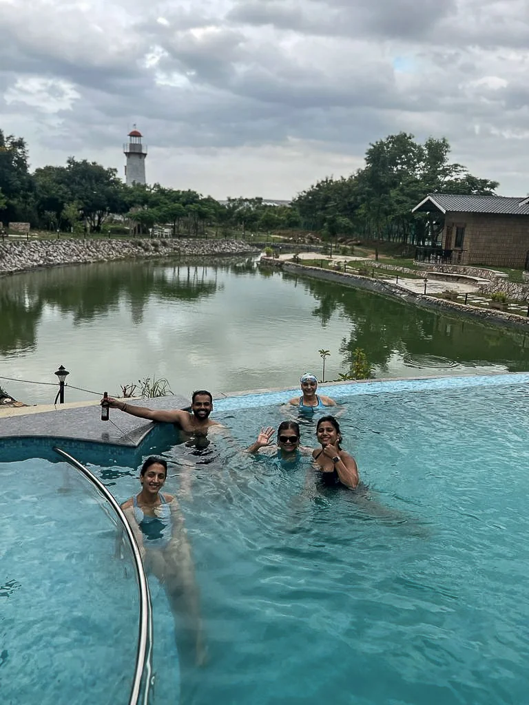 Infinity pool overlooking the rainwater pond and gardens at Arbor Road Estate, a luxury nature resort near Hyderabad.